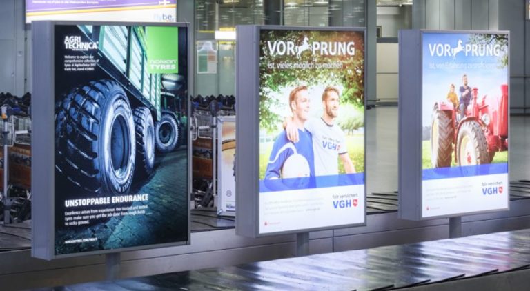 At Hannover Airport, there are three lightboxes at the baggage claim. The billboard advertisement displays an advertisement for Nokian Tyres.