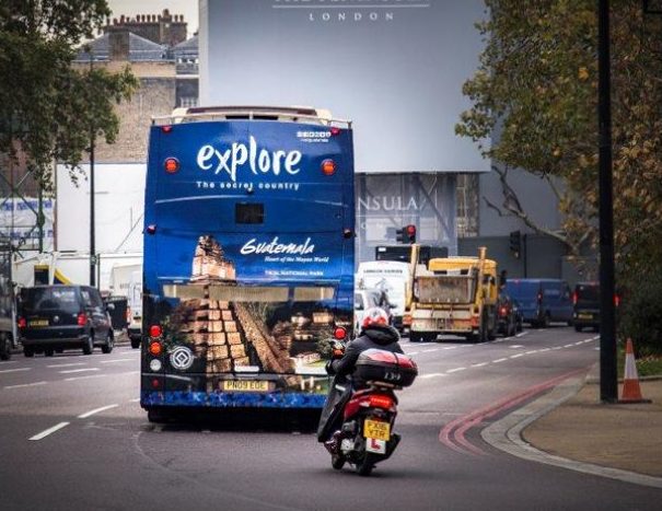 The back of a double-decker bus featuring an advertisement for 'Guatemala', while driving through London.