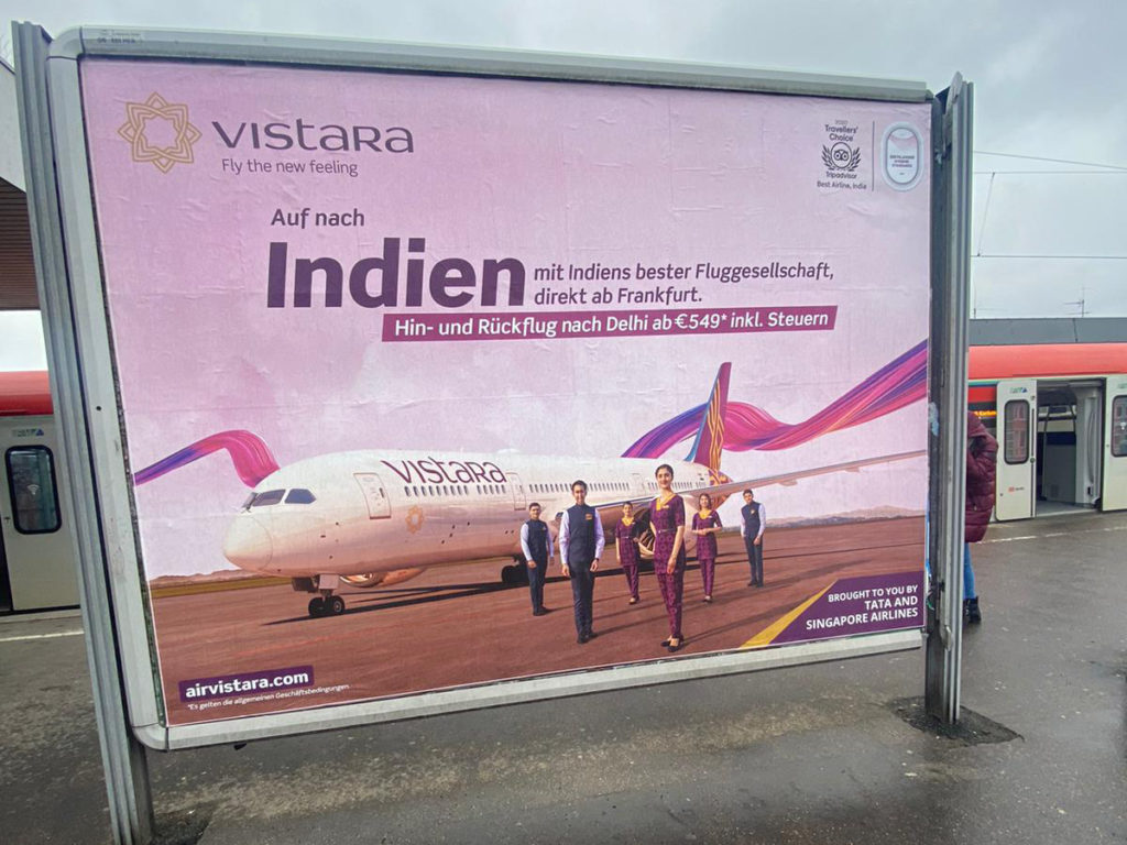 Large analog billboard advertising featuring promotions for India.