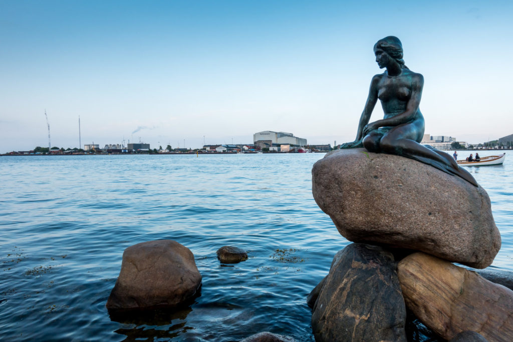 The picture shows the landmark 'The Little Mermaid' on the waterfront in Copenhagen.