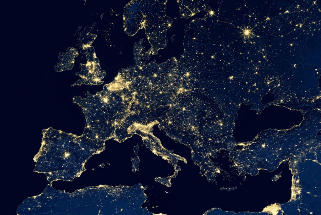 A satellite map of Europe at night, with cities brightly illuminated.