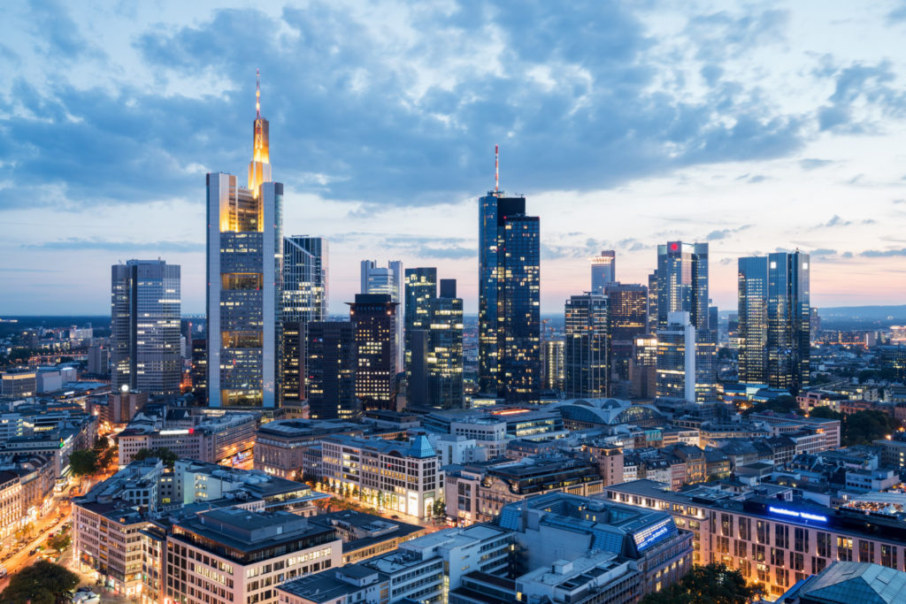 The city of Frankfurt am Main is seen from above at dusk.