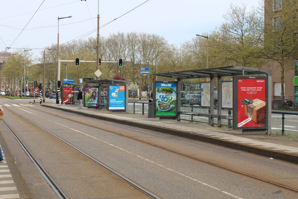 Analogue City Light Posters in the shelters at the Amsterdam RAI tram stop. The advertising spaces feature a variety of creative designs. Each shelter has one or two posters.