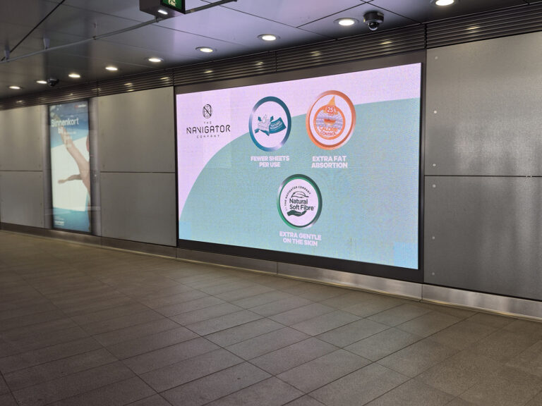 Two digital screens at the Europaplein subway station. On the left is a digital City Light Poster. On the right is a large-format digital screen in landscape orientation. The outdoor advertisement is related to the Interclean trade fair, it’s from a company that manufactures paper towels.