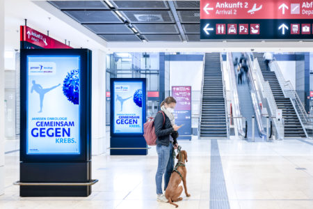 A digital City Light poster at the airport in Berlin displays advertising for the COVID-19 vaccination.