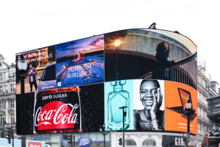 The picture displays London's 'Piccadilly Lights wall,' a digital billboard featuring several different advertisements.