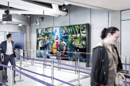 A lightbox at the Paris Airport displays tourism advertising for India.
