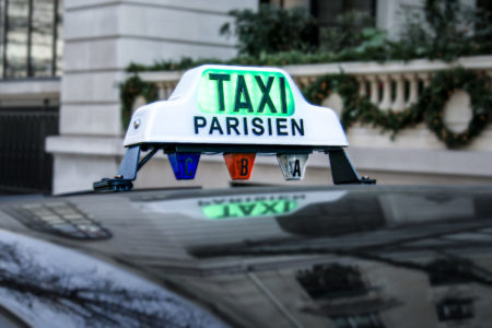 A sign on a Parisian taxi, with green illumination.